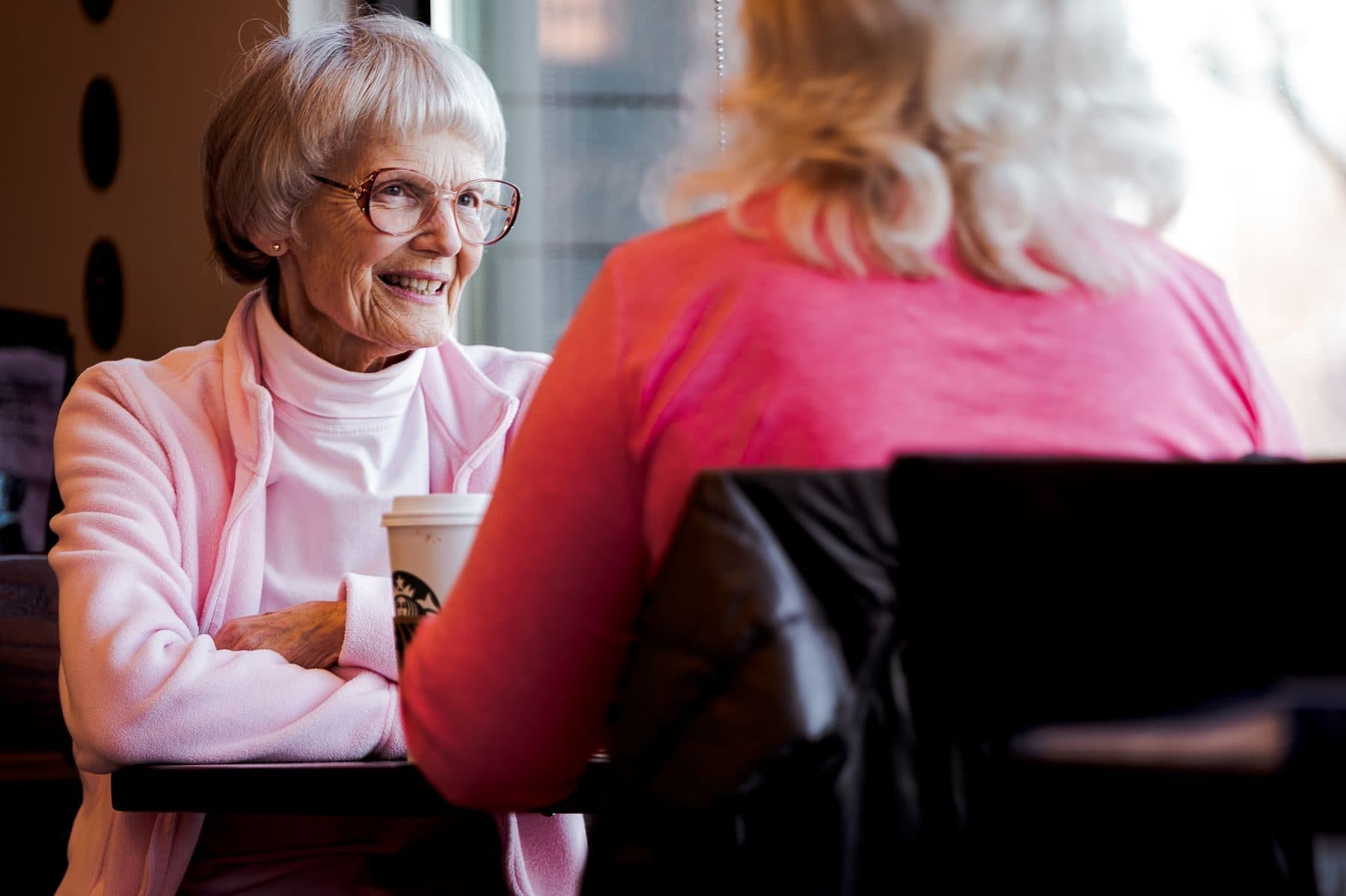 An older woman smiling during a conversation