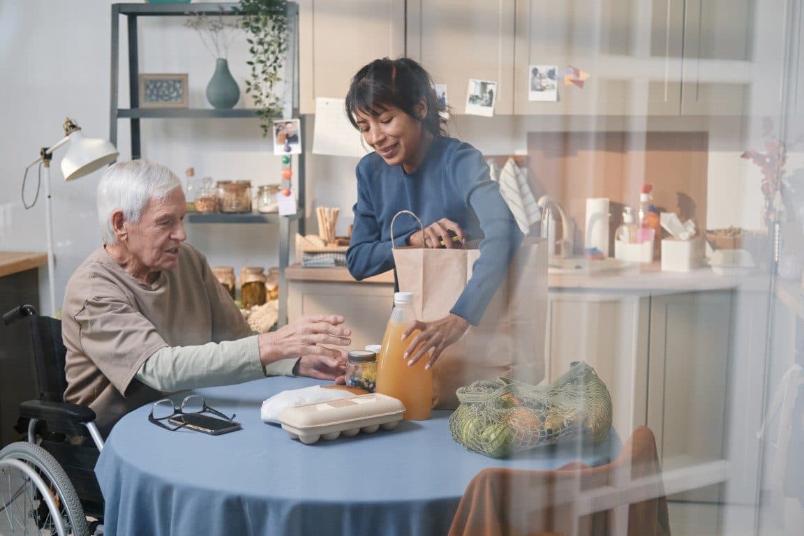 A carer helping an older man with his shopping